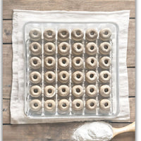 A walled clear plastic 36-cell tray for eggs used for mini donuts