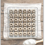 A walled clear plastic 36-cell tray for eggs used for mini donuts