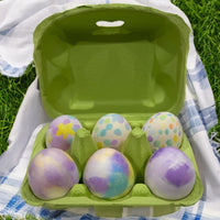 a lime green paper pulp egg carton filled with six easter eggs