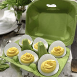 a paper pulp lime green 6-egg carton filled with deviled eggs