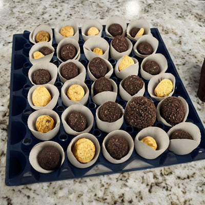 Egg Tray Filler Flat A blue plastic washable, stackable, reusable, 30-cell egg tray filled with small pastries, sitting on a marble countertop